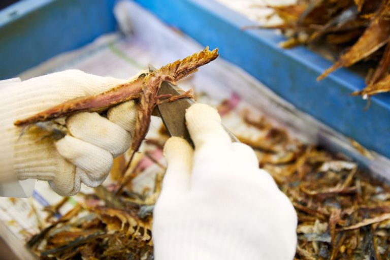 焼いたくさやを食べやすいようにスティック状に削る工程